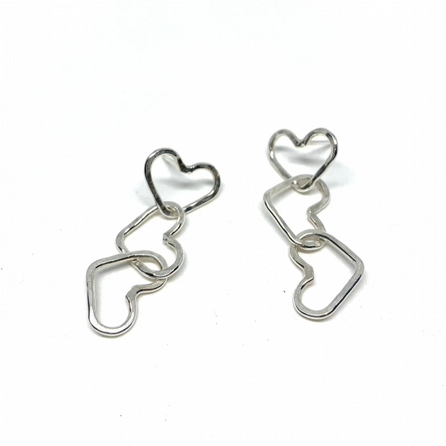 Handcrafted Triple Heart Dangle Earrings made from recycled metals, showcasing a unique design with three hearts hanging elegantly.