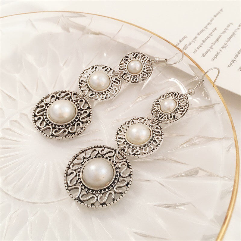 Elegant Triple Pearl Hat Earrings made of alloy, featuring three lustrous pearls in a stylish design.