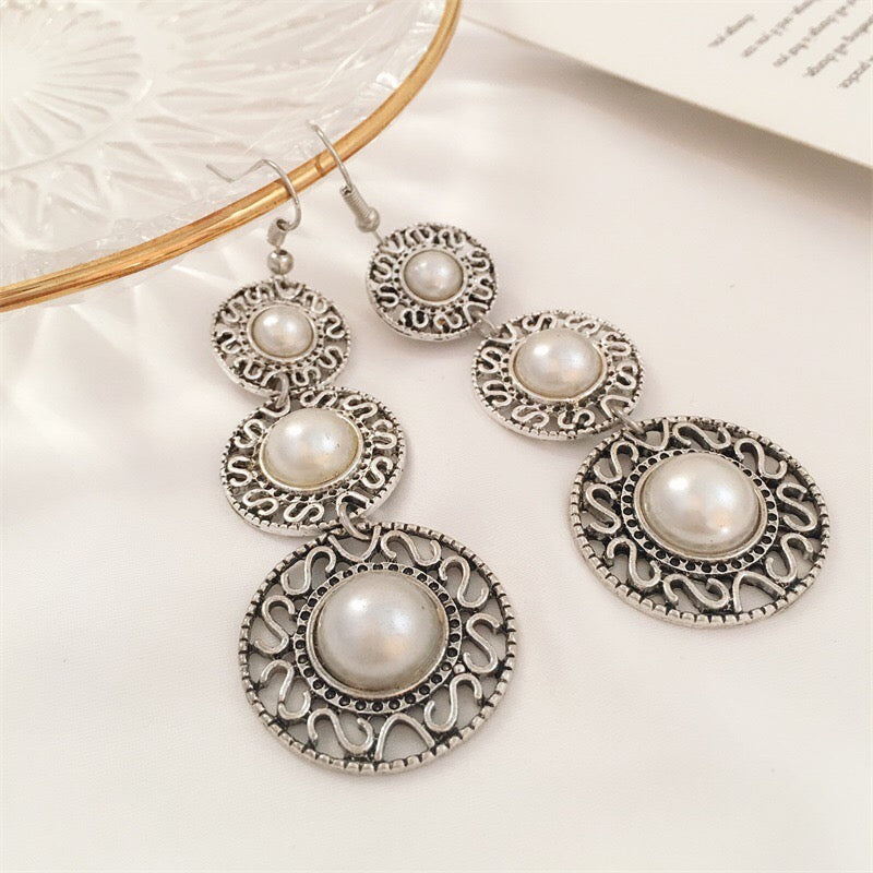 Elegant Triple Pearl Hat Earrings made of alloy, featuring three lustrous pearls in a stylish design.