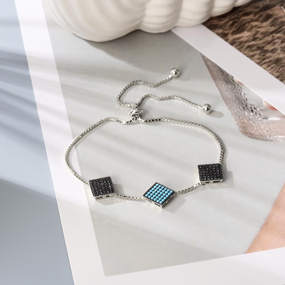 A stylish sterling silver bracelet featuring three modern 2D square charms, elegantly displayed in a gift box.