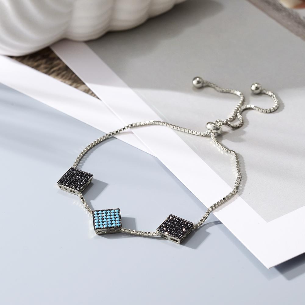 A stylish sterling silver bracelet featuring three modern 2D square charms, elegantly displayed in a gift box.