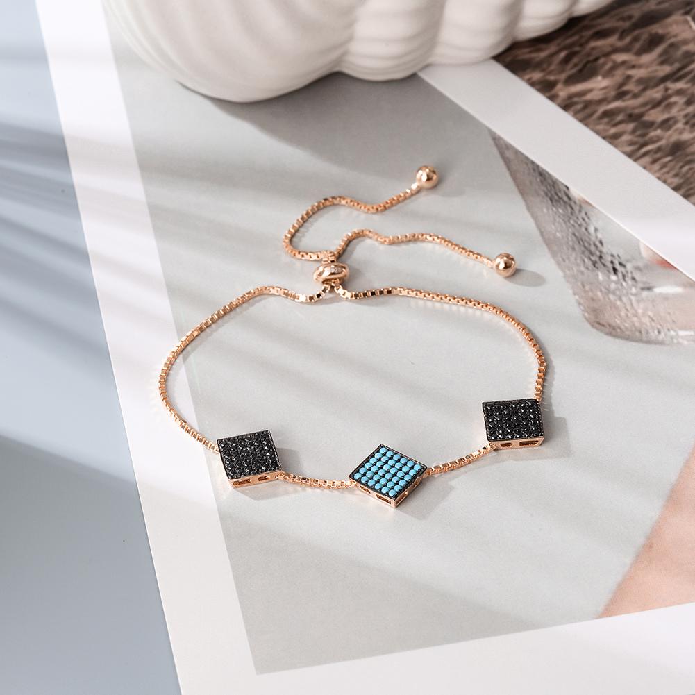 A stylish sterling silver bracelet featuring three modern 2D square charms, elegantly displayed in a gift box.