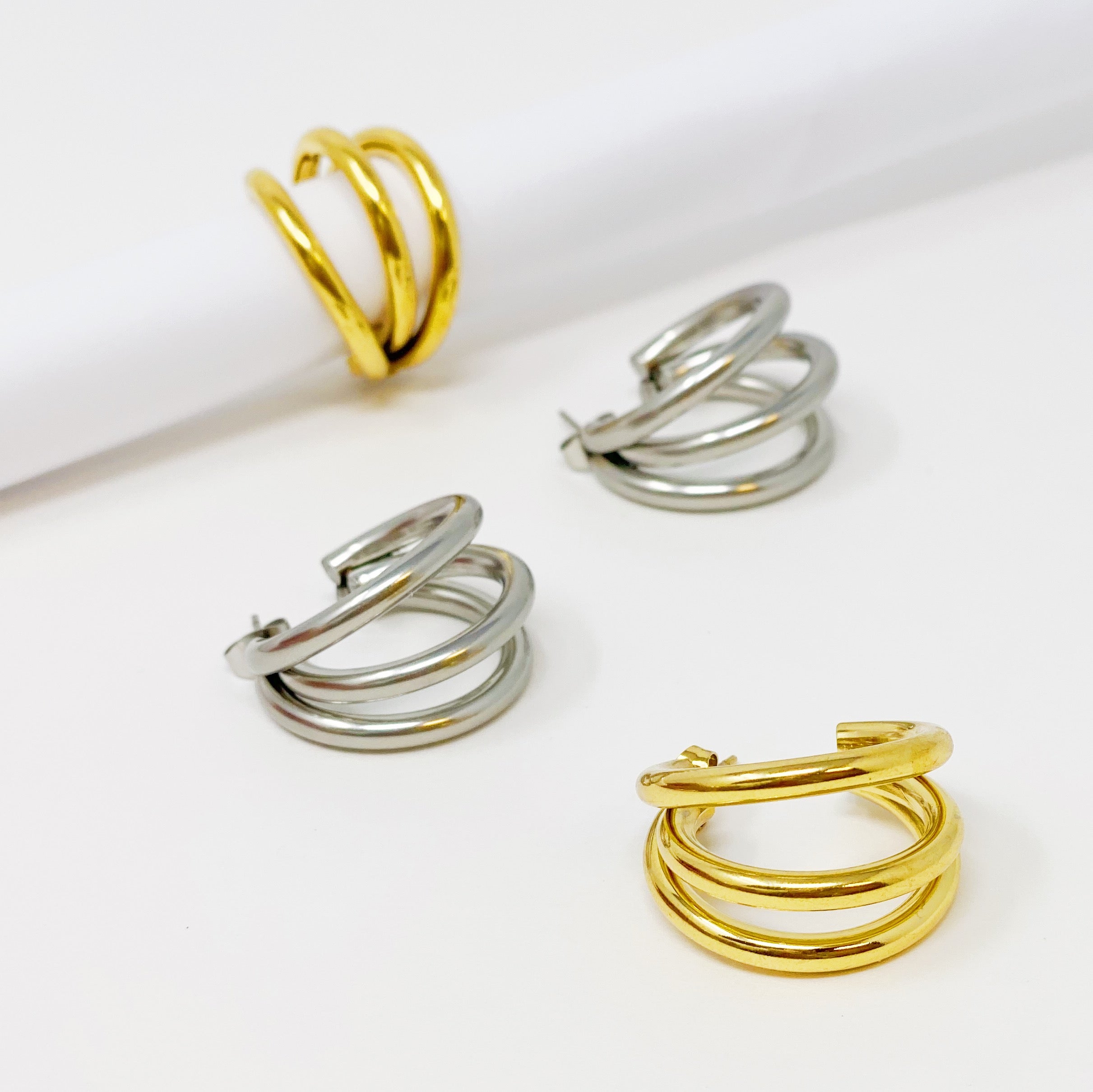 Triple hoop earrings in 18K gold plated stainless steel, showcasing a layered design perfect for any occasion.