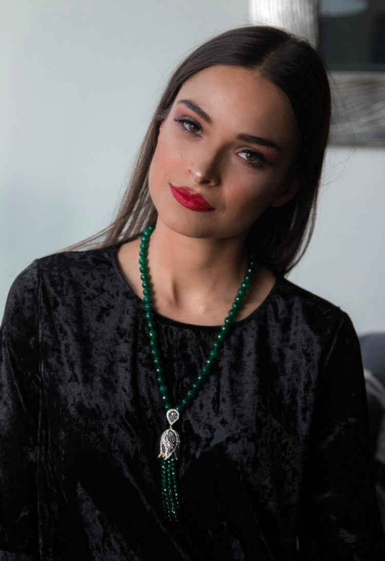 TULIP Emerald Necklace featuring a floral tassel design in yellow gold plated brass, showcasing intricate details and natural stones.