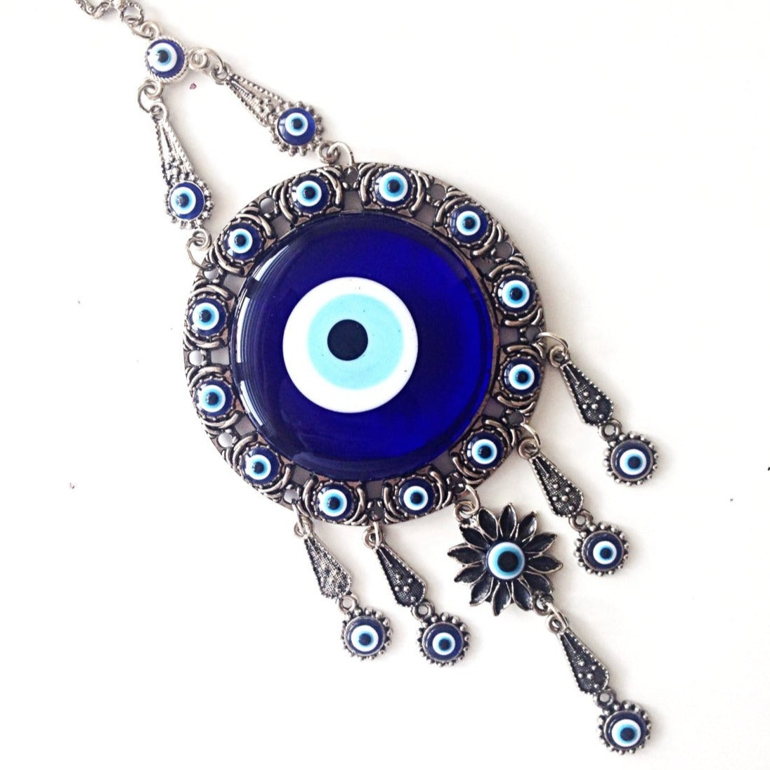 Handmade Turkish Evil Eye Home Decor featuring vibrant colors and unique metal figures, symbolizing protection and good luck.