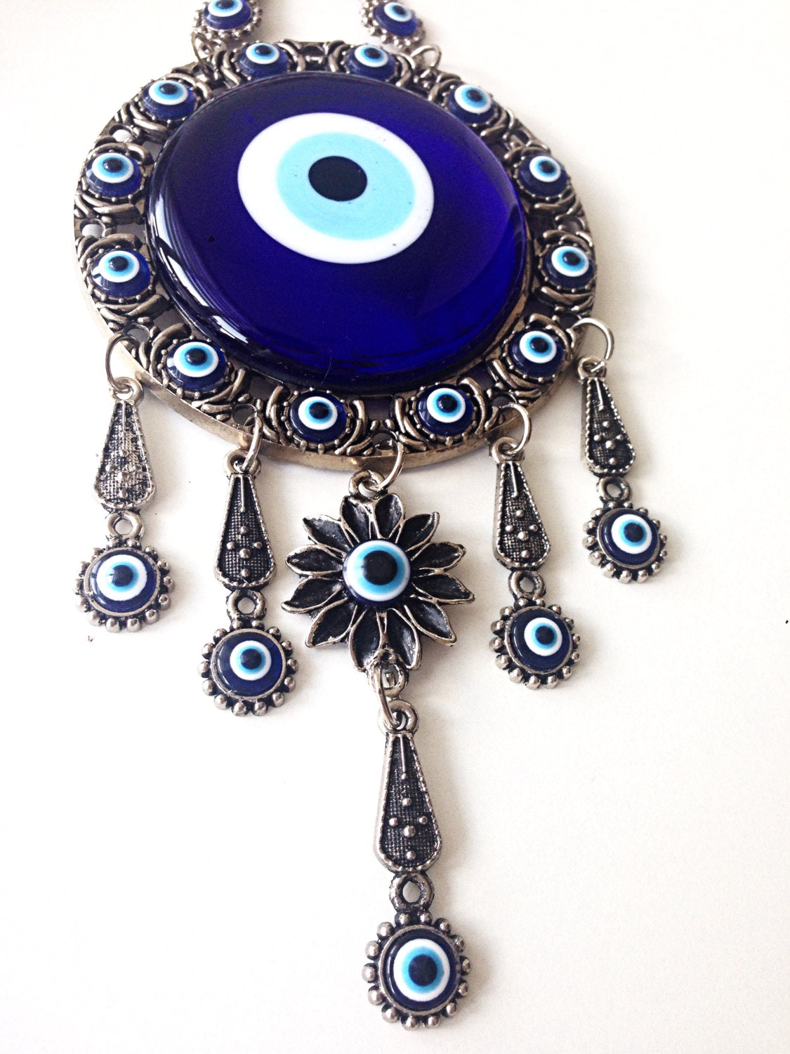 Handmade Turkish Evil Eye Home Decor featuring vibrant colors and unique metal figures, symbolizing protection and good luck.