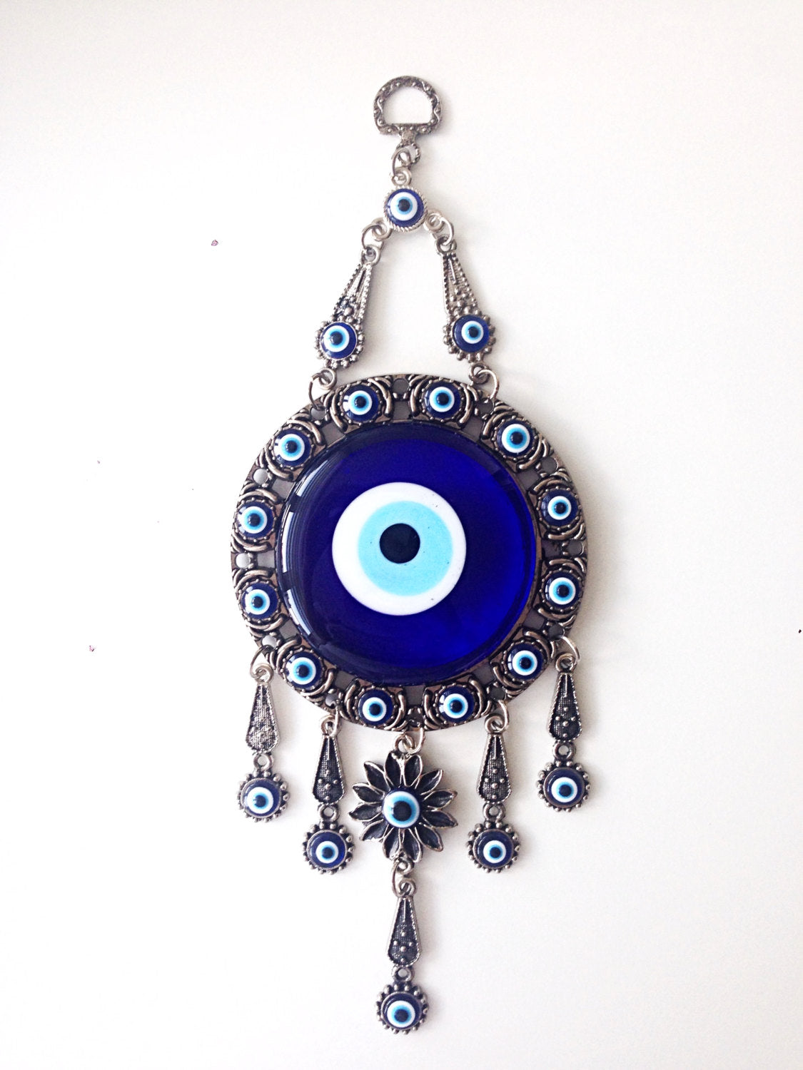 Handmade Turkish Evil Eye Home Decor featuring vibrant colors and unique metal figures, symbolizing protection and good luck.