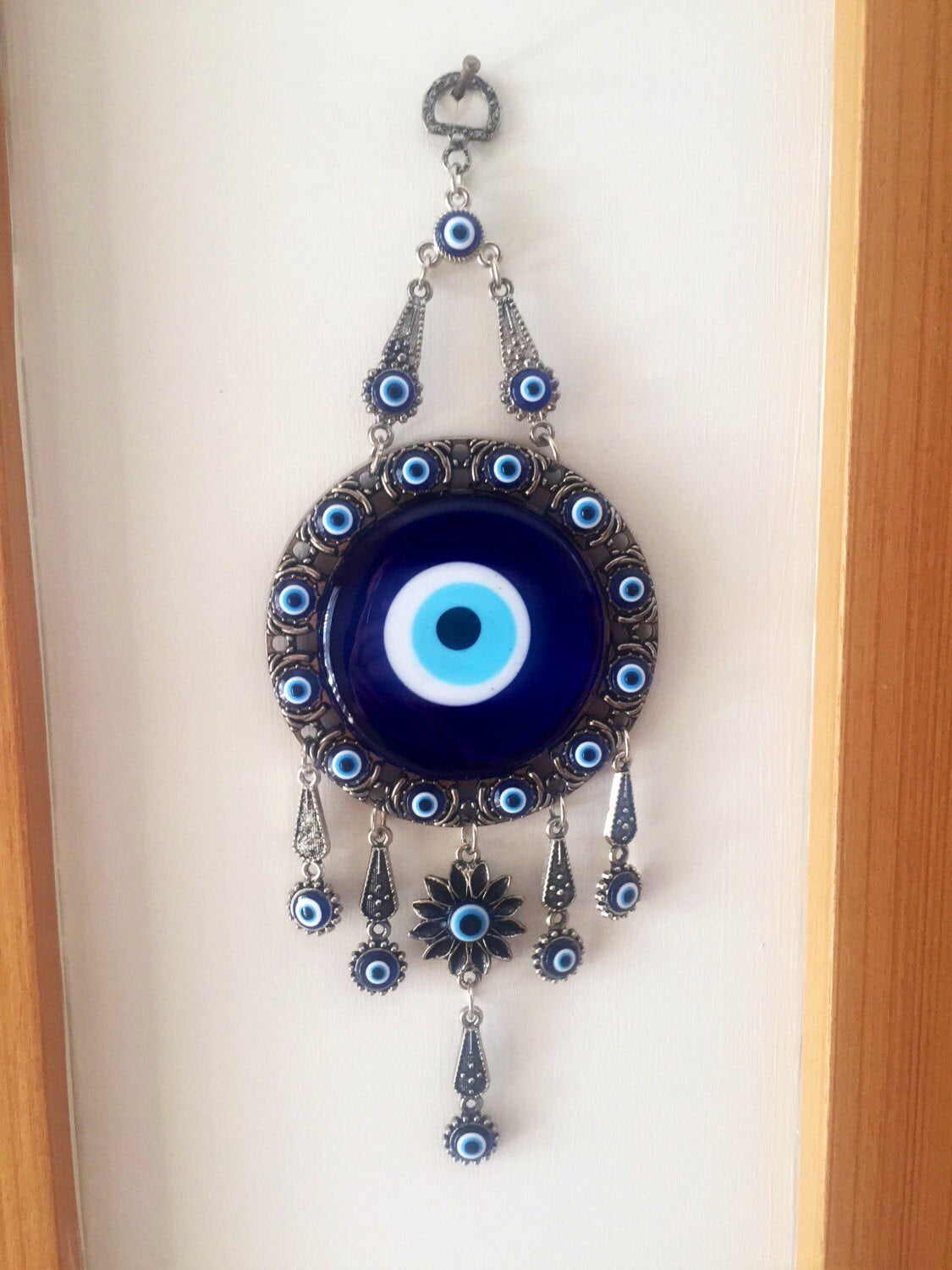 Handmade Turkish Evil Eye Home Decor featuring vibrant colors and unique metal figures, symbolizing protection and good luck.