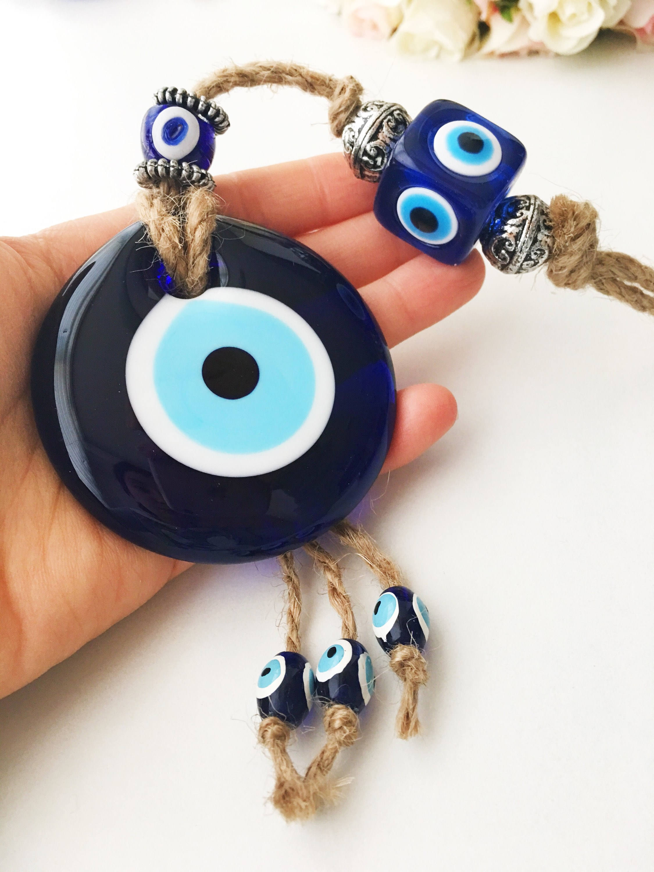 Handmade Turkish Evil Eye Home Decoration featuring blue glass beads and intricate design, perfect for wall hanging.