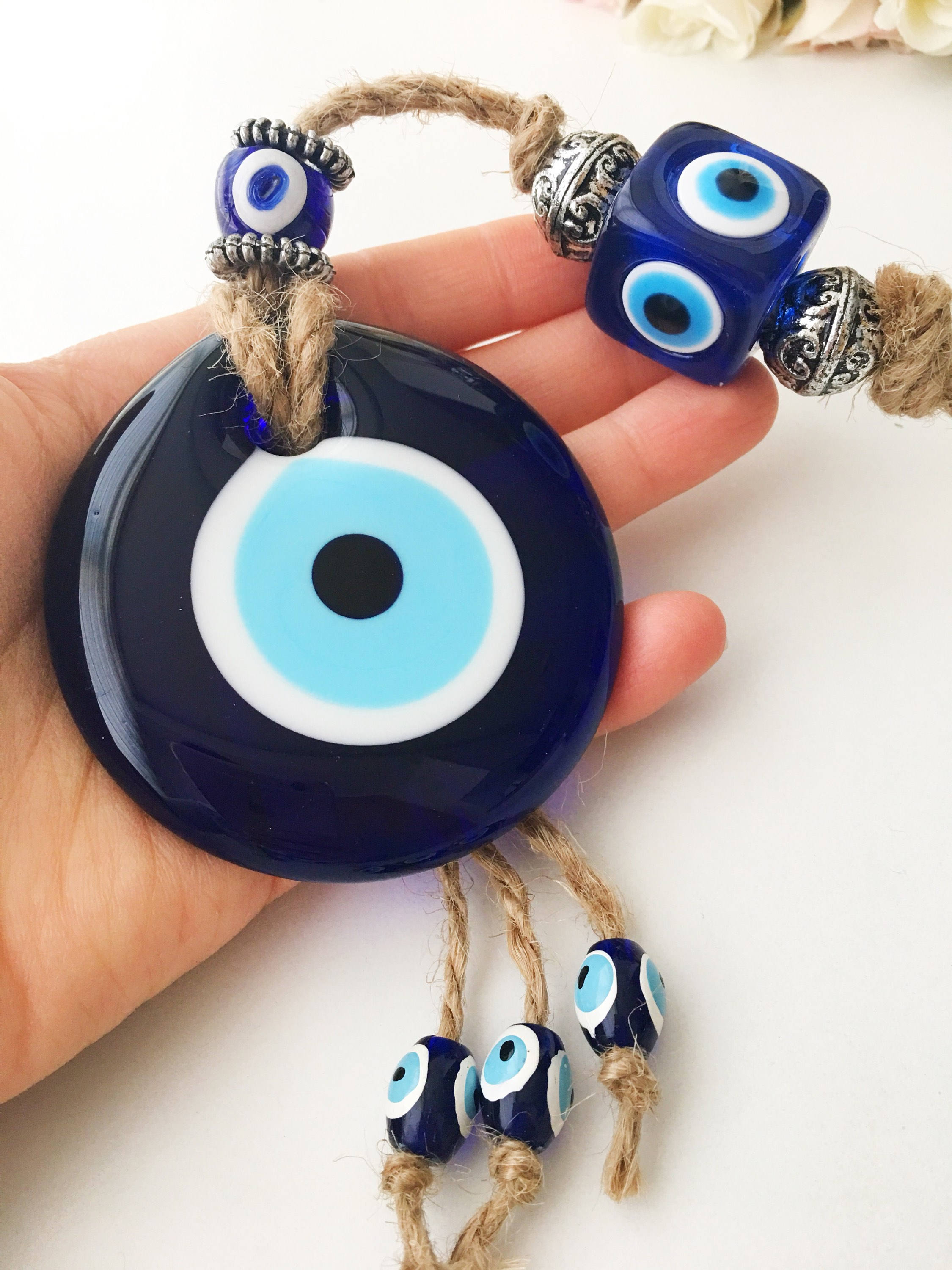 Handmade Turkish Evil Eye Home Decoration featuring blue glass beads and intricate design, perfect for wall hanging.