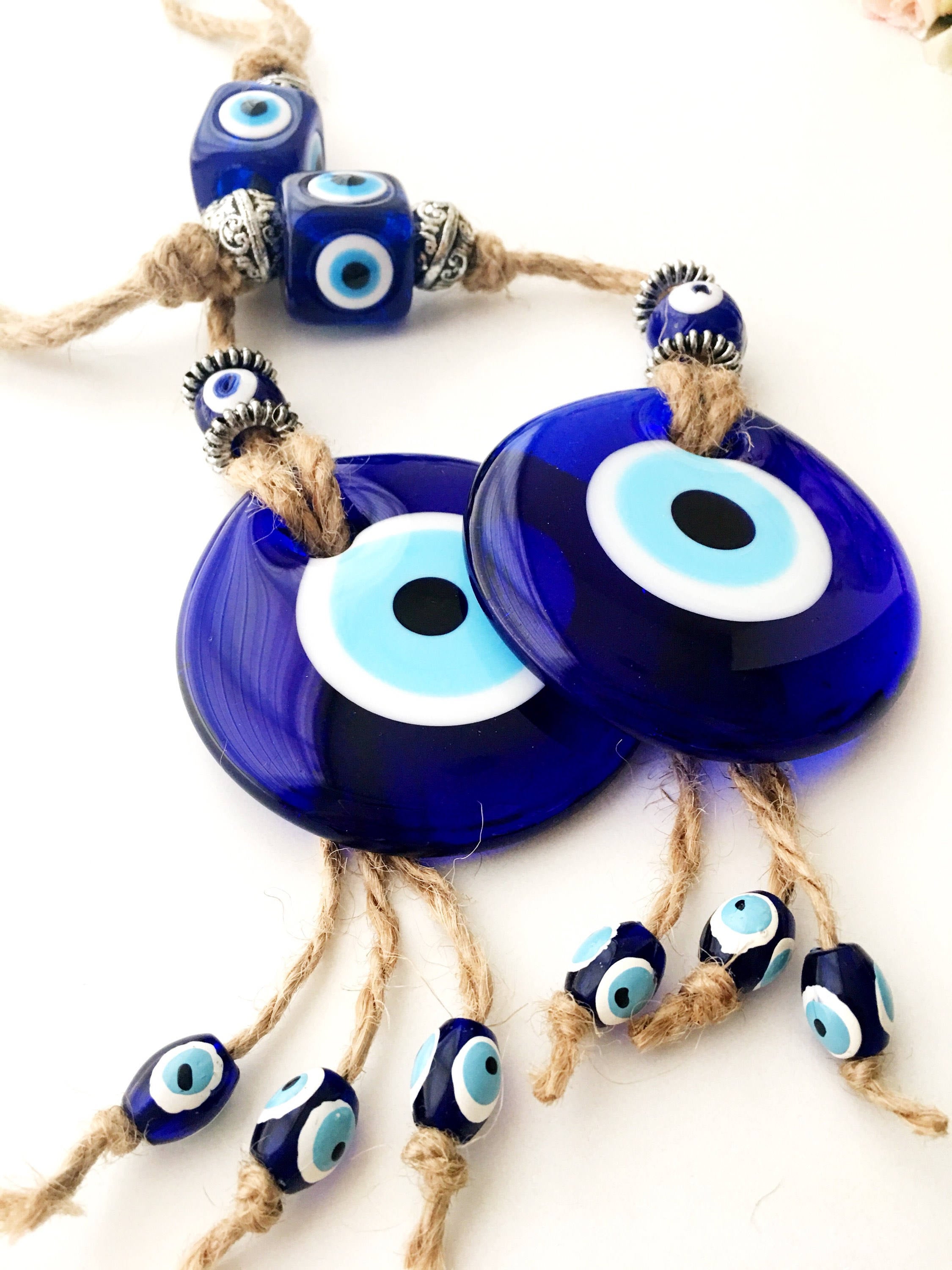 Handmade Turkish Evil Eye Home Decoration featuring blue glass beads and intricate design, perfect for wall hanging.