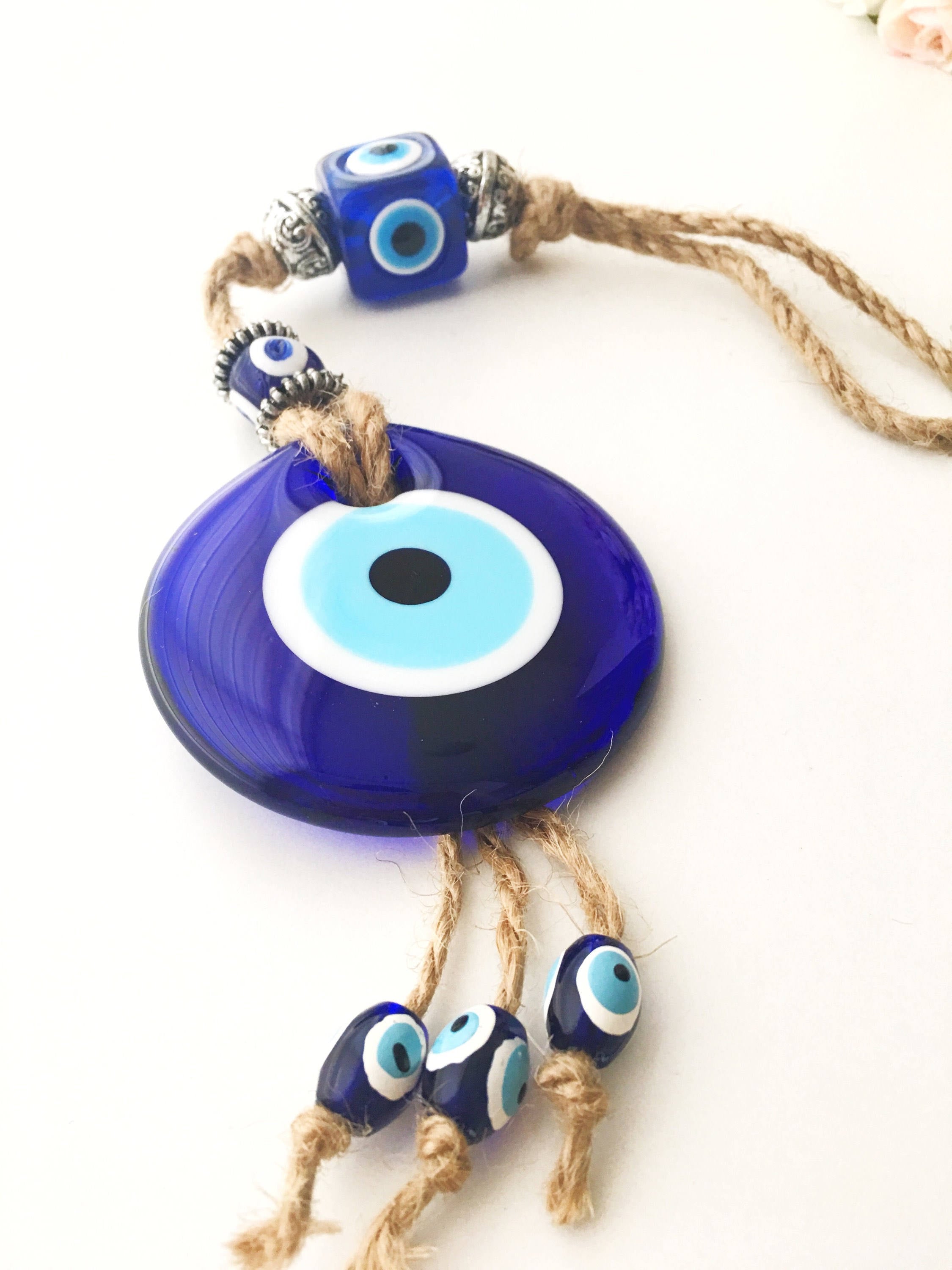 Handmade Turkish Evil Eye Home Decoration featuring blue glass beads and intricate design, perfect for wall hanging.