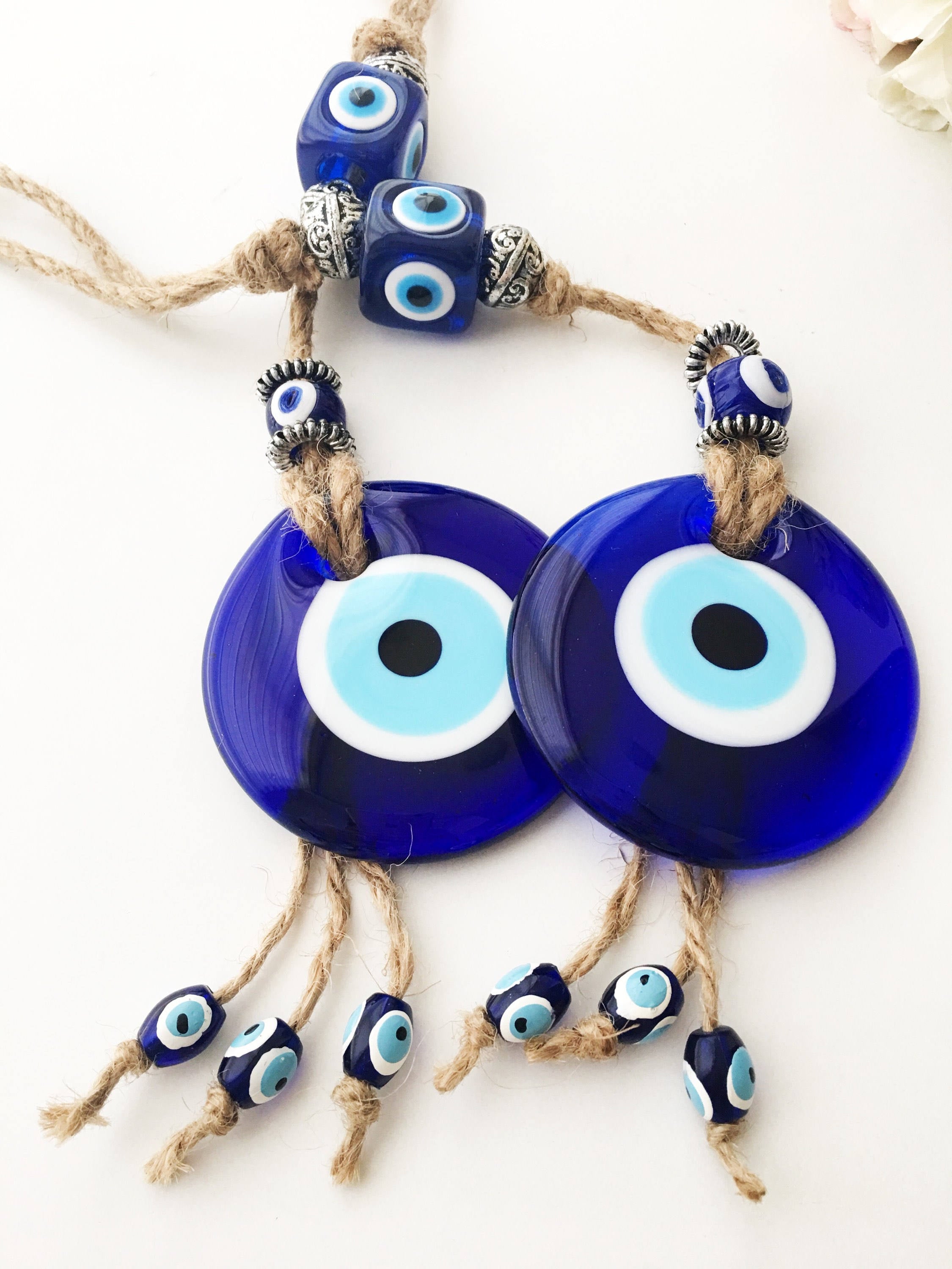 Handmade Turkish Evil Eye Home Decoration featuring blue glass beads and intricate design, perfect for wall hanging.