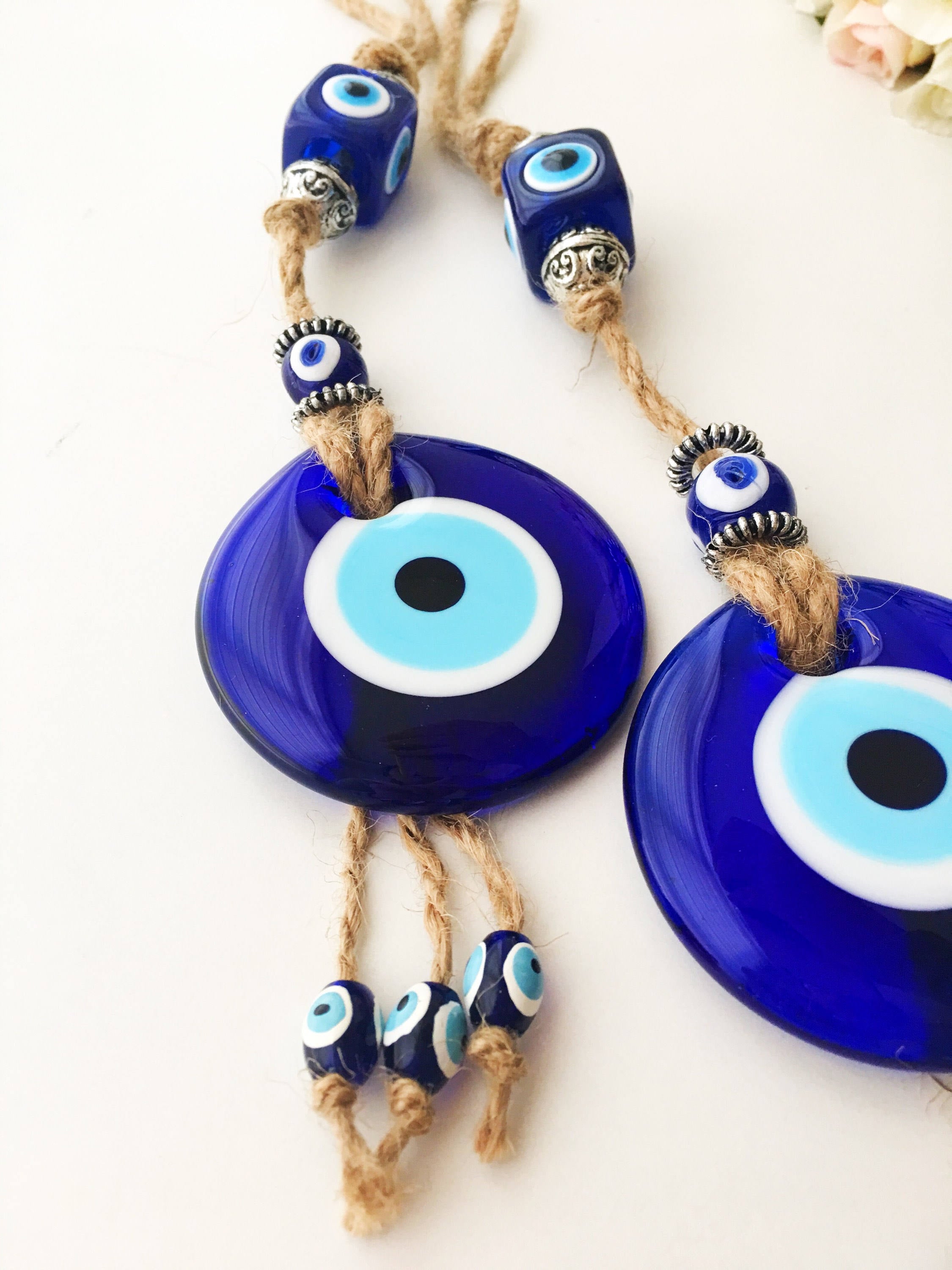 Handmade Turkish Evil Eye Home Decoration featuring blue glass beads and intricate design, perfect for wall hanging.