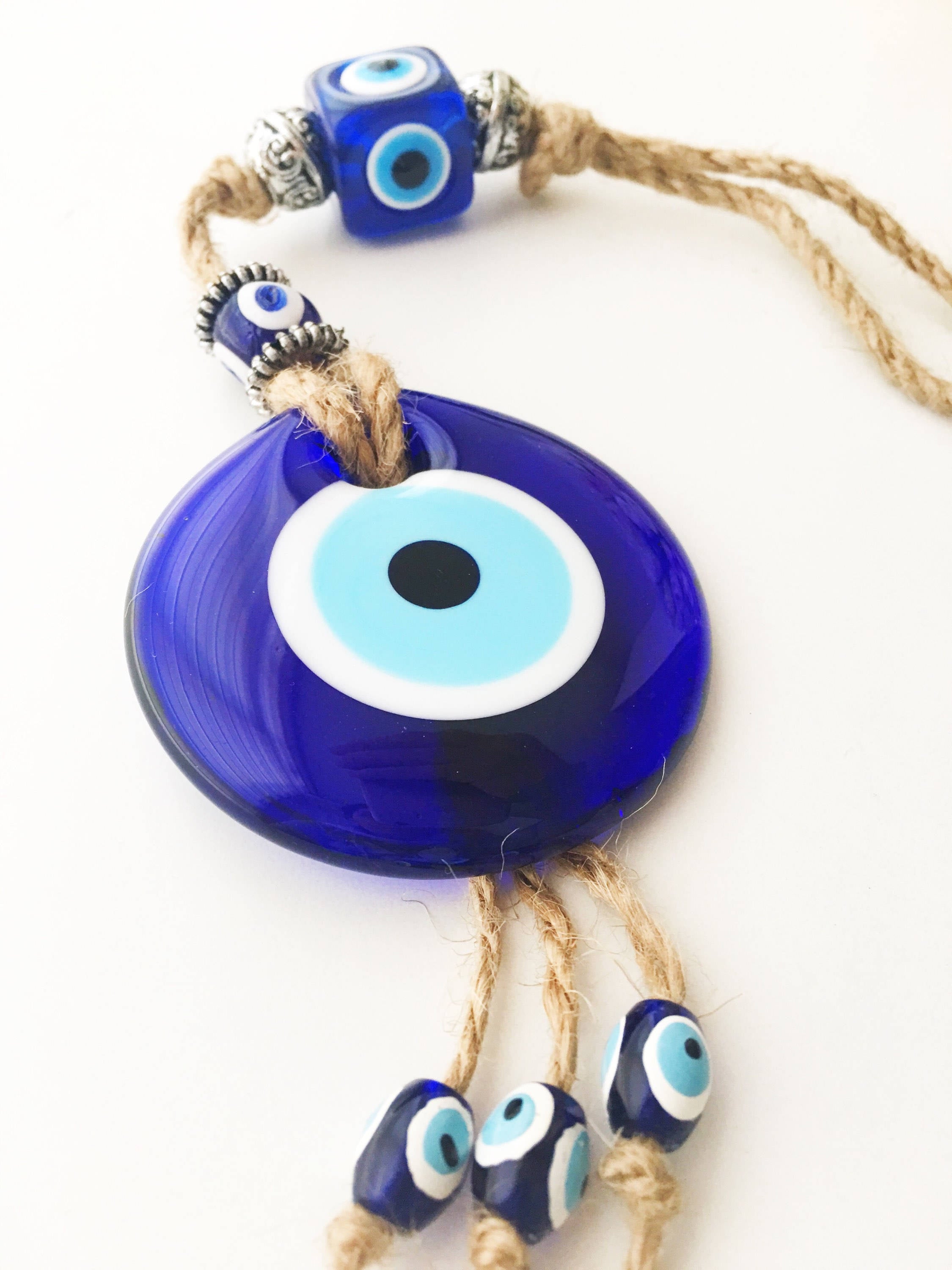 Handmade Turkish Evil Eye Home Decoration featuring blue glass beads and intricate design, perfect for wall hanging.