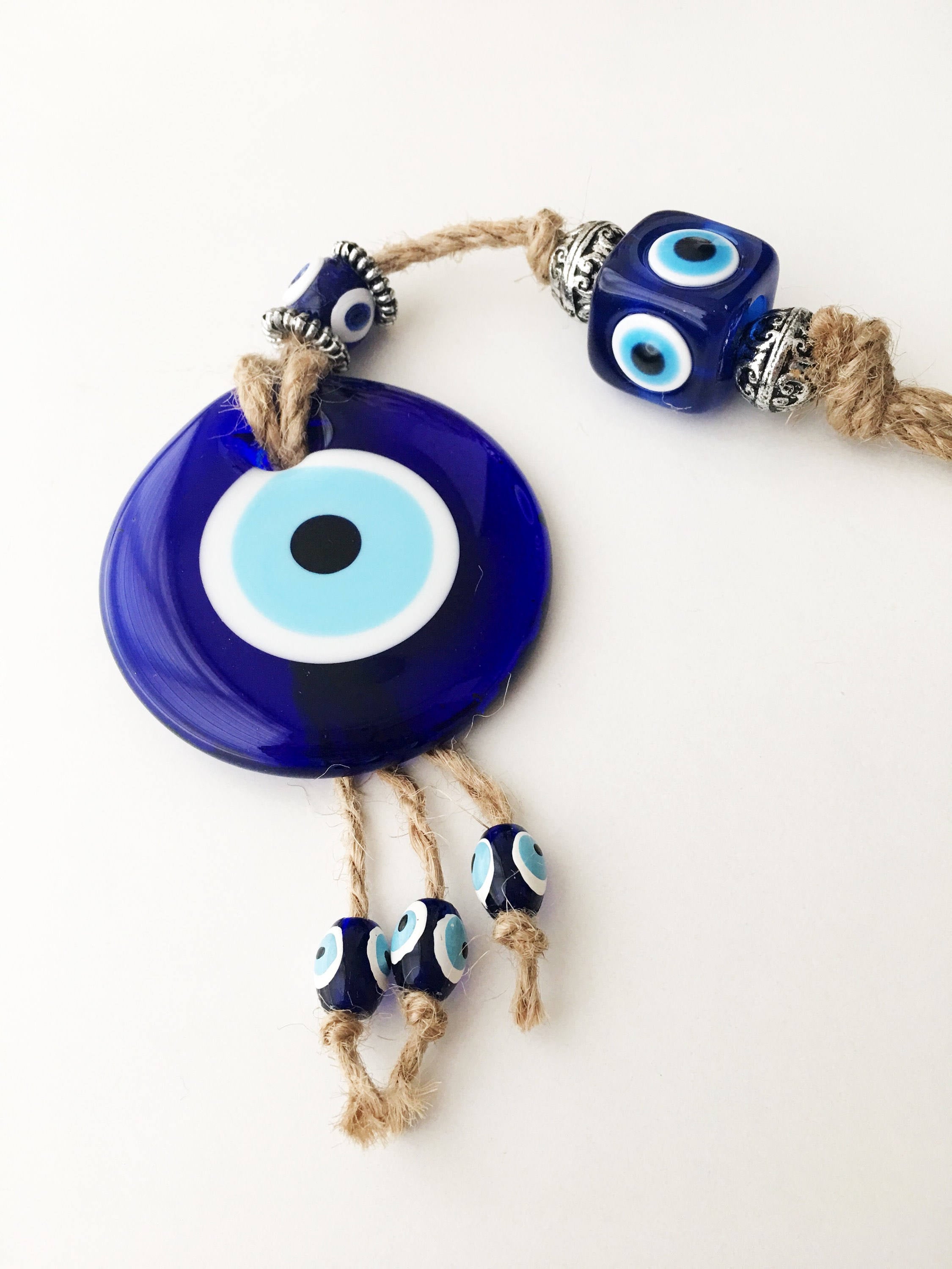 Handmade Turkish Evil Eye Home Decoration featuring blue glass beads and intricate design, perfect for wall hanging.