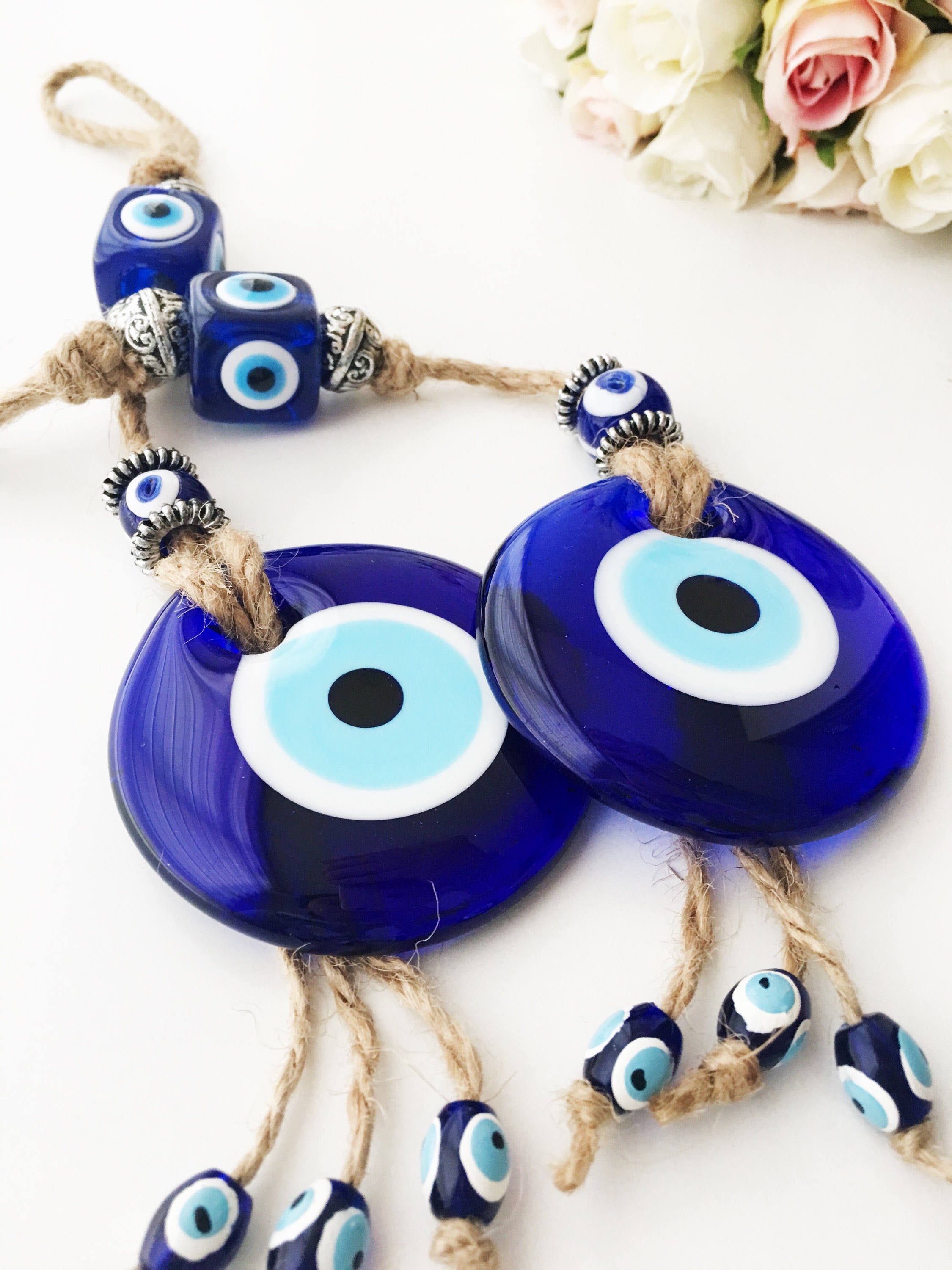 Handmade Turkish Evil Eye Home Decoration featuring blue glass beads and intricate design, perfect for wall hanging.