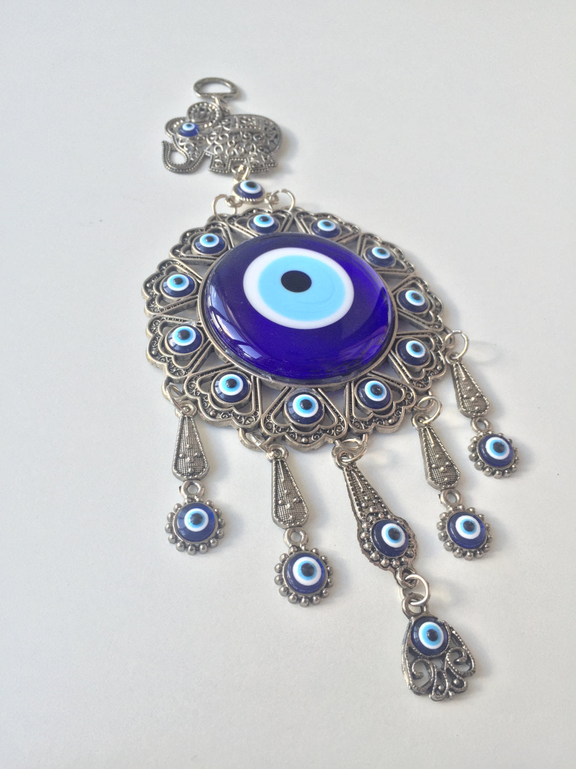 Handmade Turkish Evil Eye Wall Hanging featuring unique metal figures and glass evil eyes, symbolizing protection and good luck.