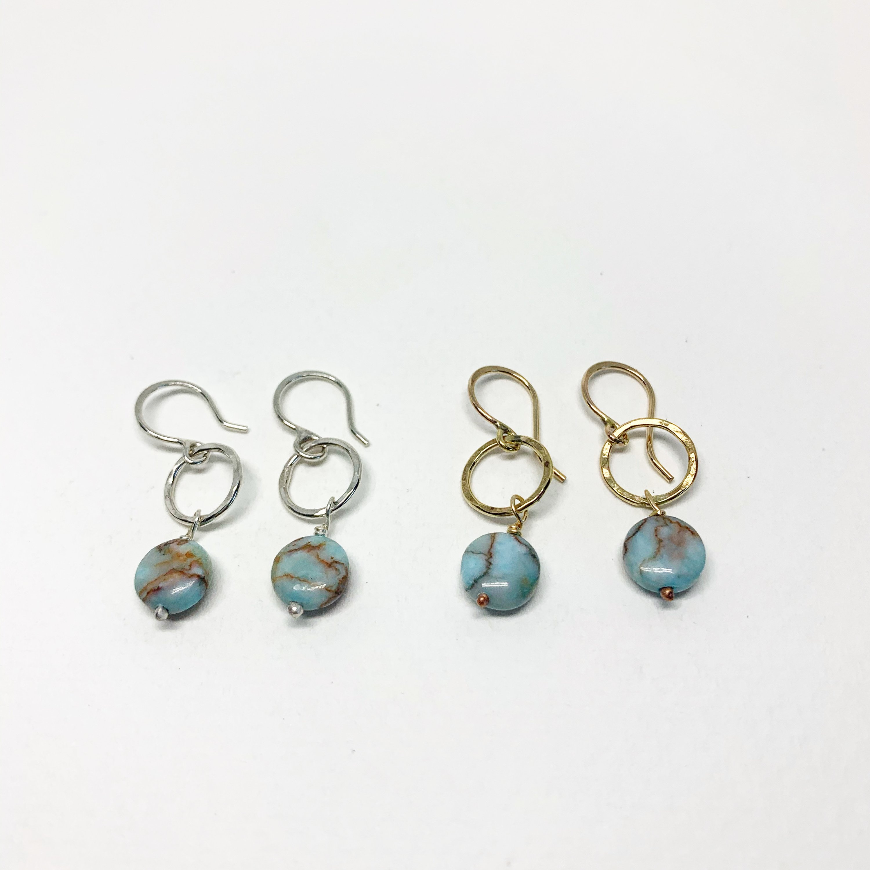 A pair of handmade turquoise disc drop earrings featuring 8mm blue turquoise round discs, hanging from a hammered circle in sterling silver or yellow gold fill.