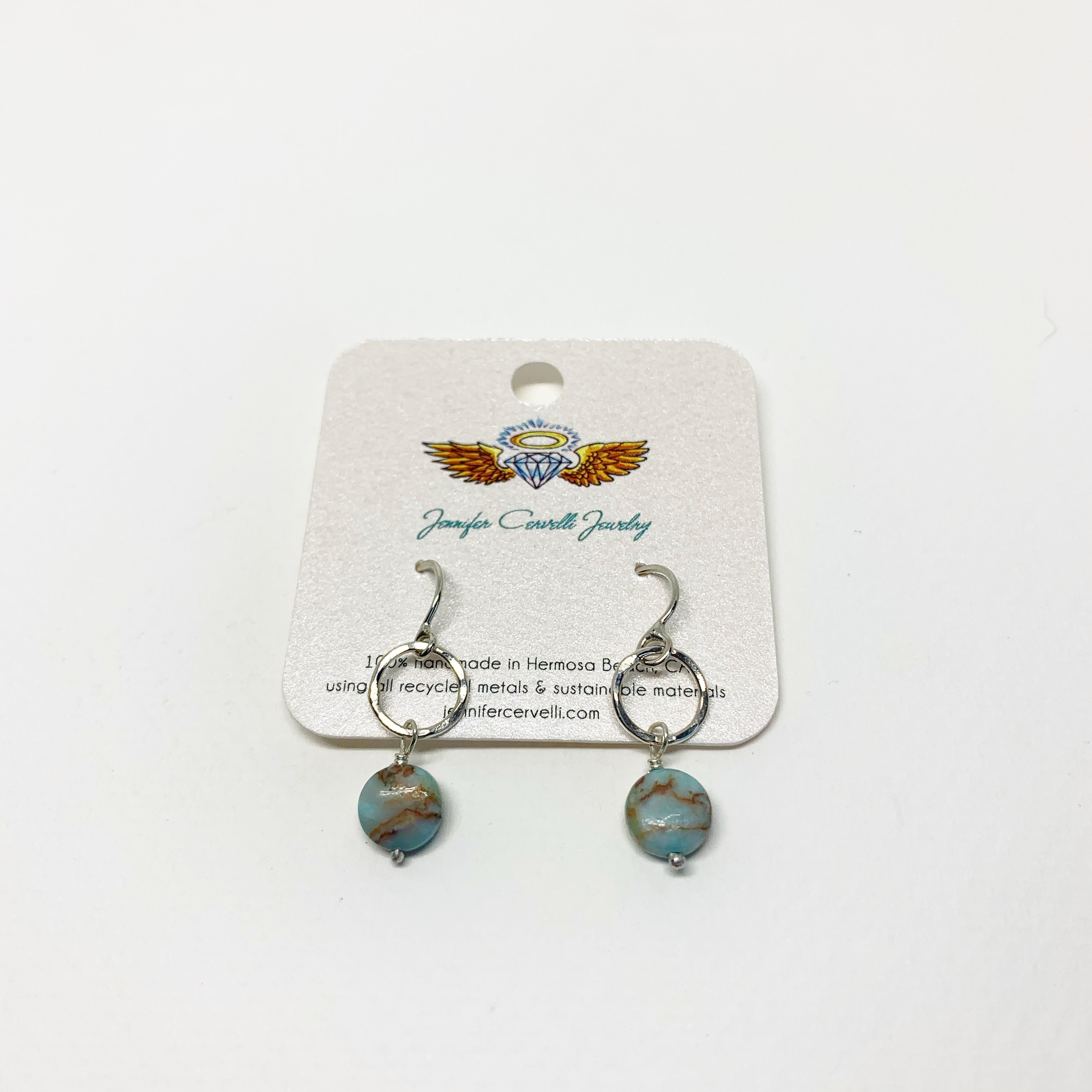 A pair of handmade turquoise disc drop earrings featuring 8mm blue turquoise round discs, hanging from a hammered circle in sterling silver or yellow gold fill.