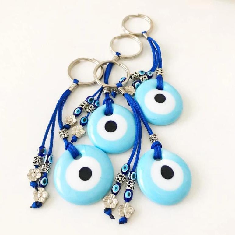 Turquoise evil eye keychain with glass beads, featuring a protective charm design.