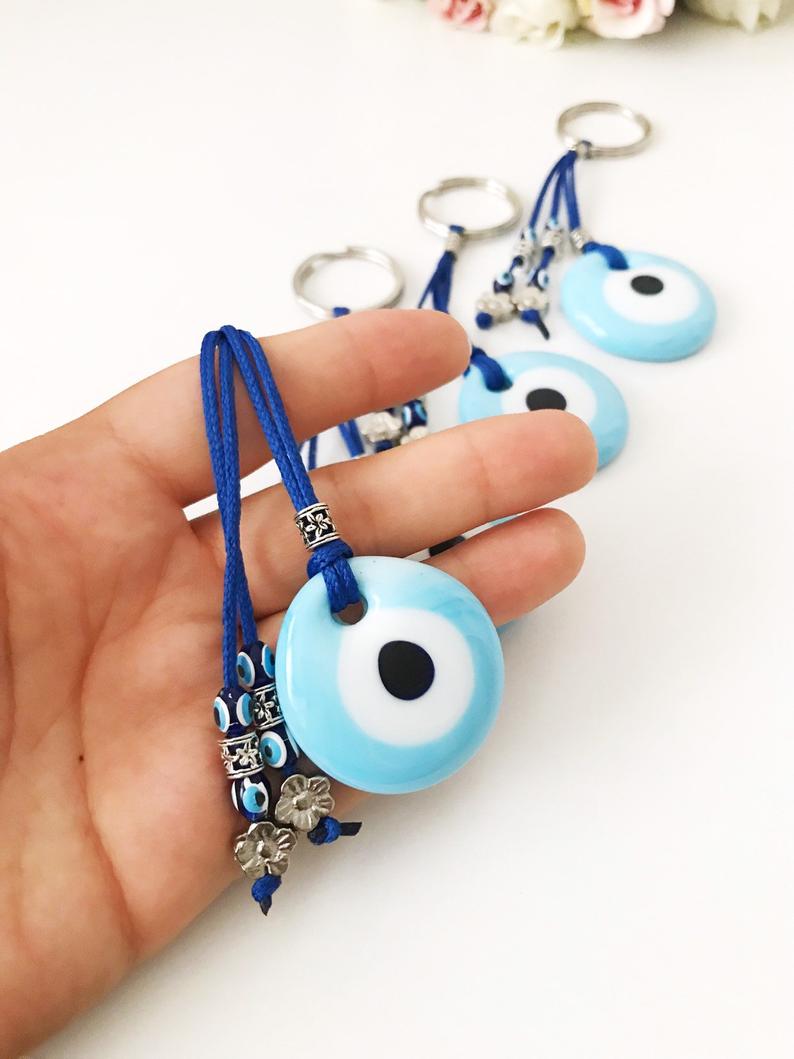 Turquoise evil eye keychain with glass beads, featuring a protective charm design.