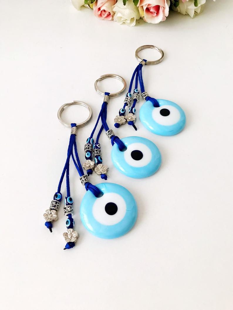 Turquoise evil eye keychain with glass beads, featuring a protective charm design.