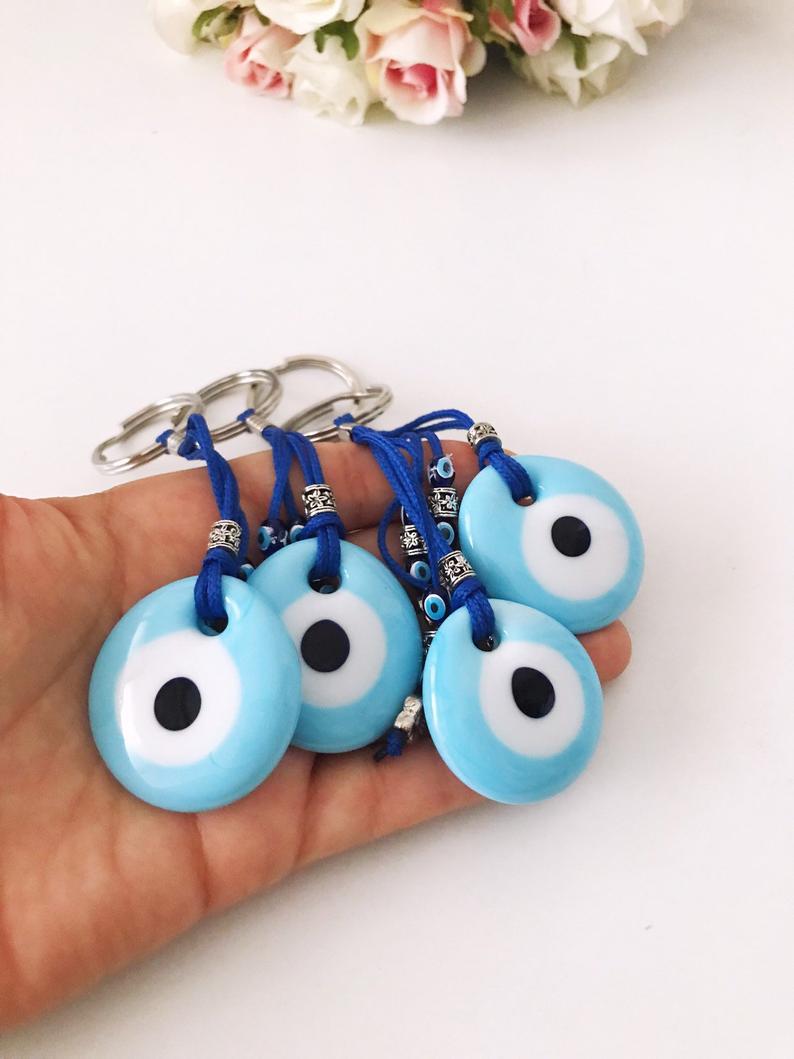 Turquoise evil eye keychain with glass beads, featuring a protective charm design.