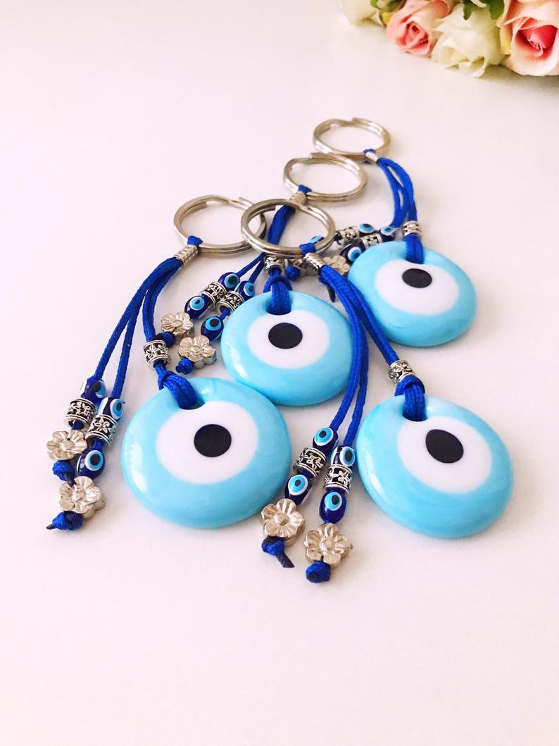 Turquoise evil eye keychain with glass beads, featuring a protective charm design.