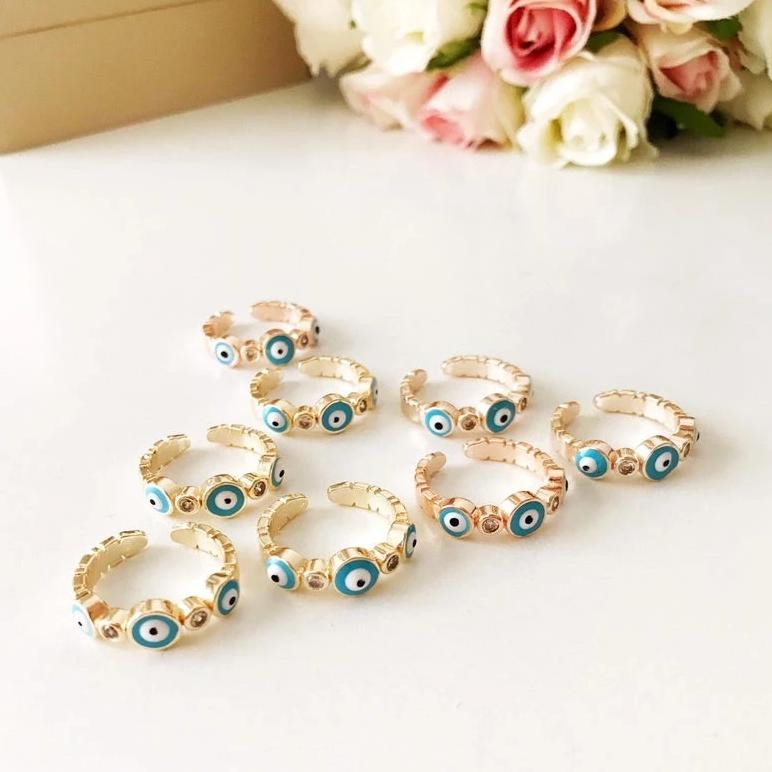 A beautiful adjustable Turquoise Evil Eye Ring featuring a turquoise bead and zircon accents, set in rose gold, symbolizing protection and style.