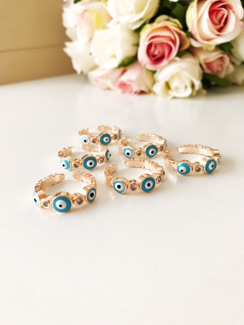 A beautiful adjustable Turquoise Evil Eye Ring featuring a turquoise bead and zircon accents, set in rose gold, symbolizing protection and style.