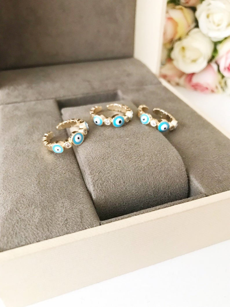 A beautiful adjustable Turquoise Evil Eye Ring featuring a turquoise bead and zircon accents, set in rose gold, symbolizing protection and style.