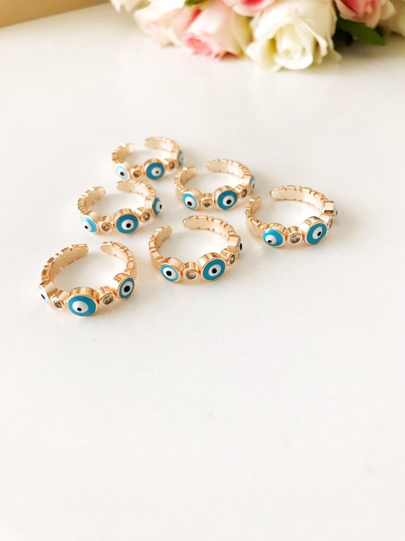 A beautiful adjustable Turquoise Evil Eye Ring featuring a turquoise bead and zircon accents, set in rose gold, symbolizing protection and style.