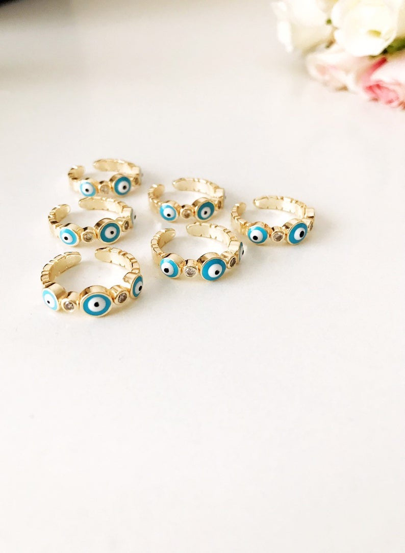 A beautiful adjustable Turquoise Evil Eye Ring featuring a turquoise bead and zircon accents, set in rose gold, symbolizing protection and style.