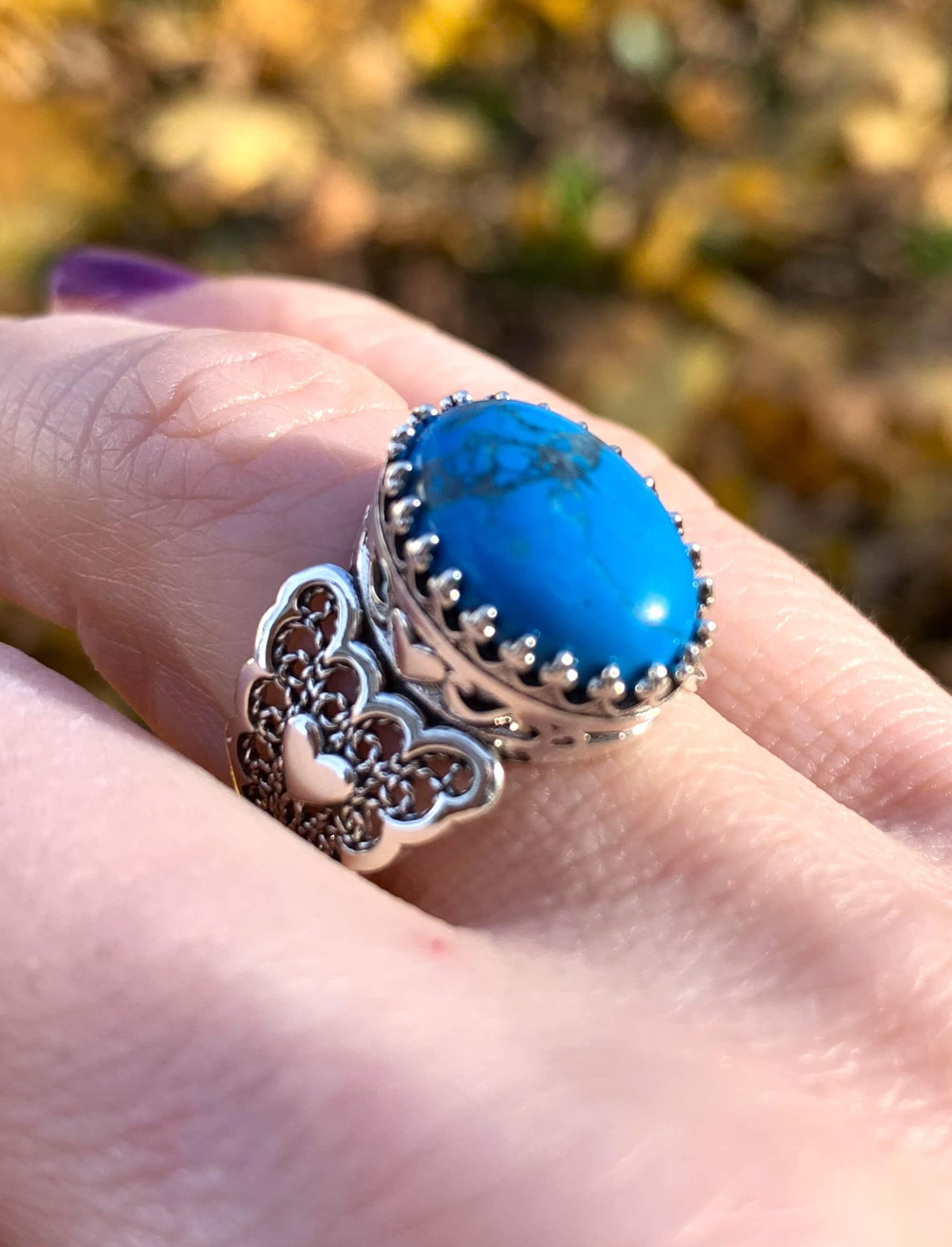 Turquoise gemstone double heart filigree ring made of 925 sterling silver, showcasing intricate design and vibrant teal color.