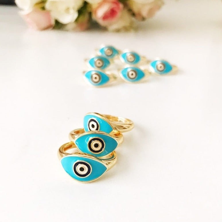 Turquoise Oval Evil Eye Ring featuring an adjustable gold band and a vibrant turquoise evil eye bead, symbolizing protection and elegance.