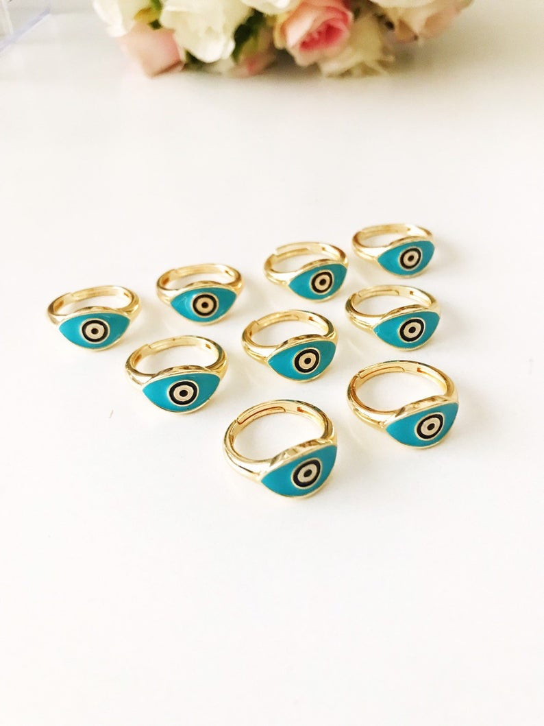 Turquoise Oval Evil Eye Ring featuring an adjustable gold band and a vibrant turquoise evil eye bead, symbolizing protection and elegance.