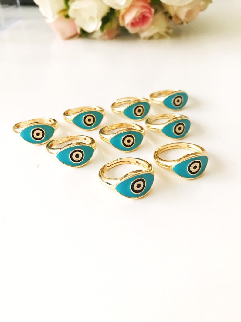 Turquoise Oval Evil Eye Ring featuring an adjustable gold band and a vibrant turquoise evil eye bead, symbolizing protection and elegance.