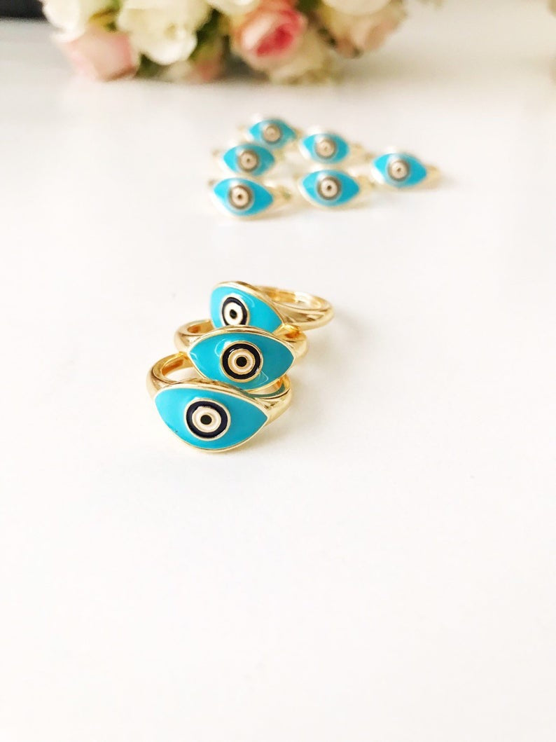 Turquoise Oval Evil Eye Ring featuring an adjustable gold band and a vibrant turquoise evil eye bead, symbolizing protection and elegance.