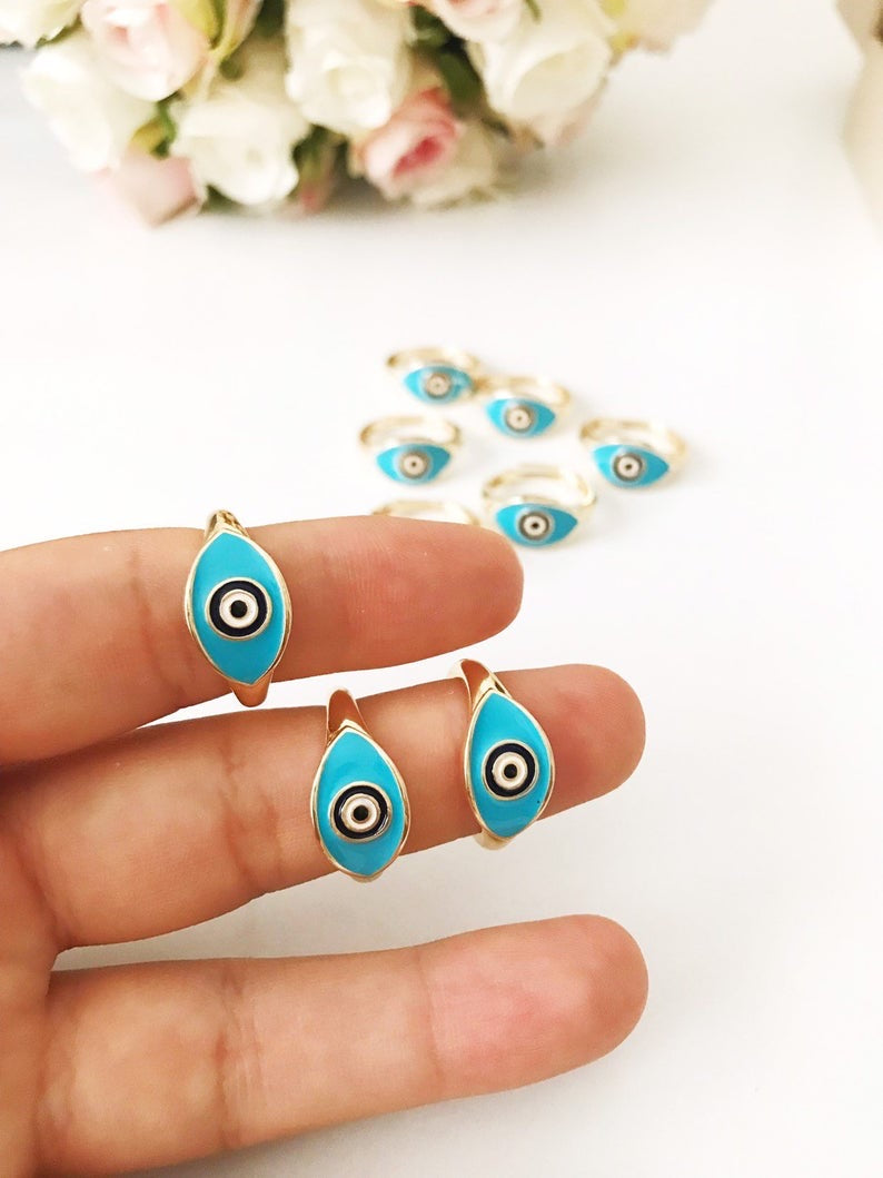 Turquoise Oval Evil Eye Ring featuring an adjustable gold band and a vibrant turquoise evil eye bead, symbolizing protection and elegance.