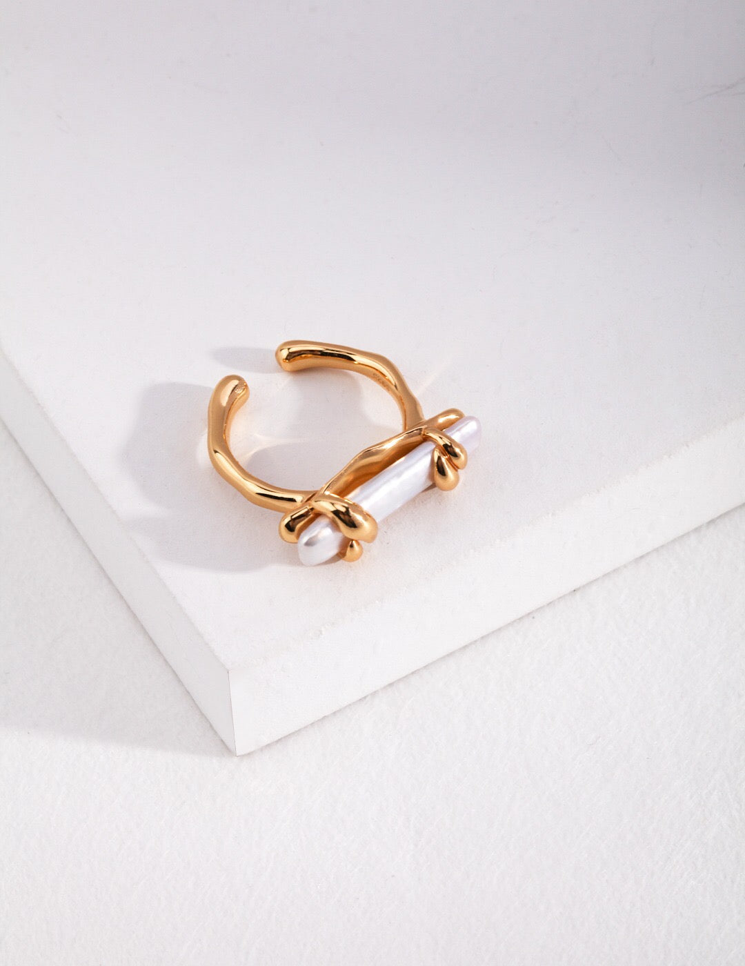 A beautiful Twine Pearl Ring featuring genuine freshwater pearls set in sterling silver with gold vermeil plating, showcasing elegance and craftsmanship.