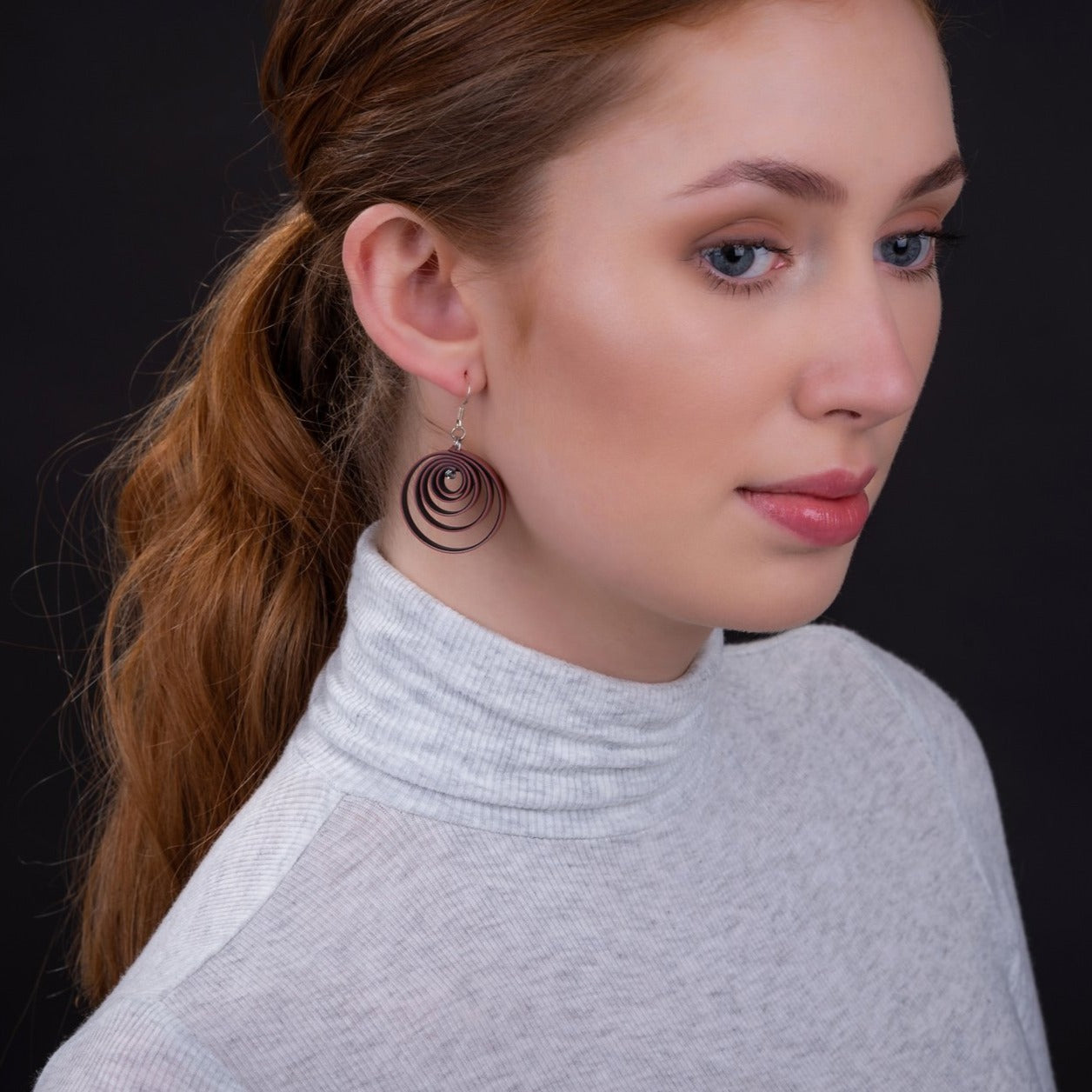 Twirl Recycled Rubber Vegan Earrings in pastel colors, handcrafted from recycled materials with sterling silver hooks.