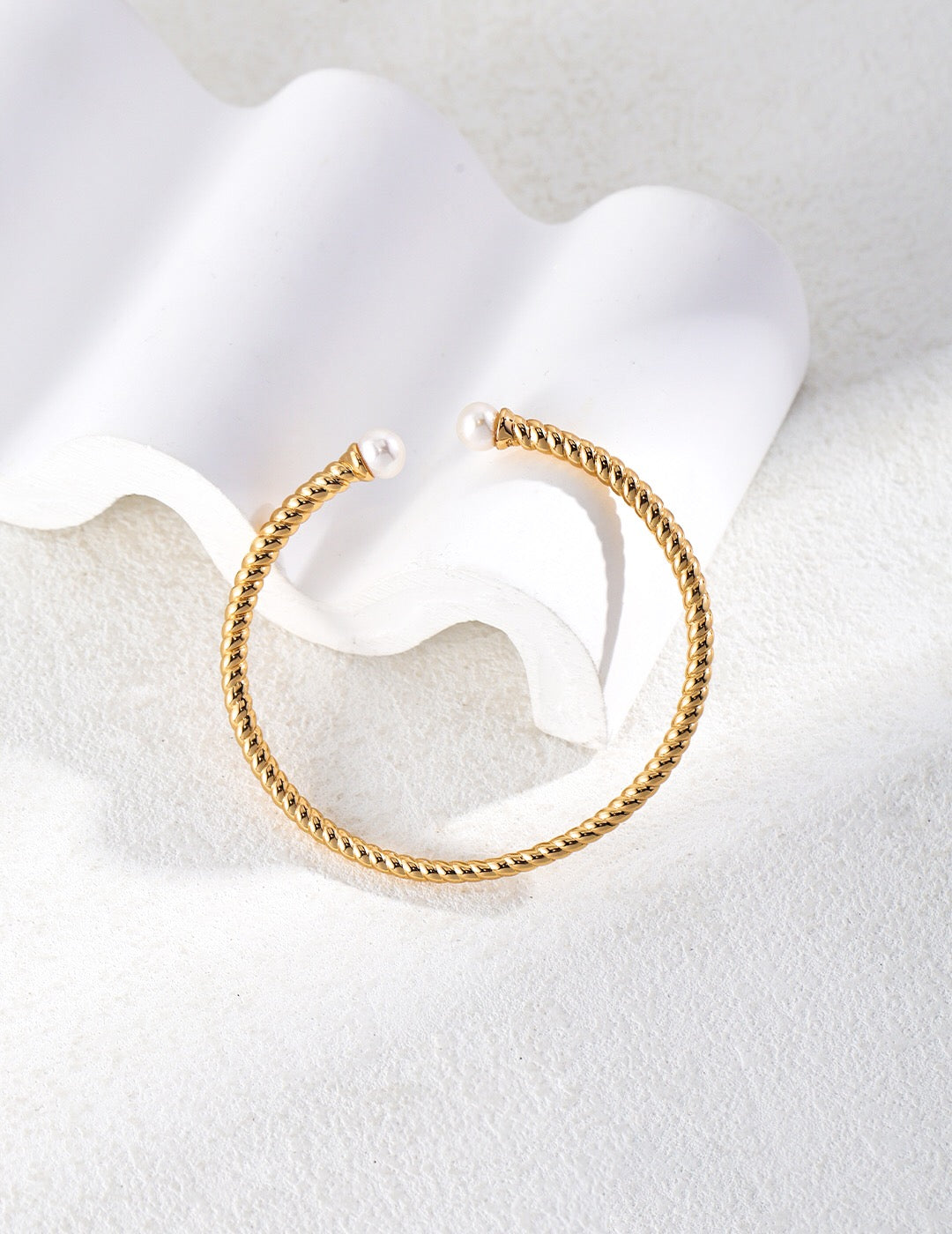 Elegant Twisted Cable Pearl Cuff Bracelet featuring natural freshwater pearls and gold vermeil, showcasing a unique baroque design.