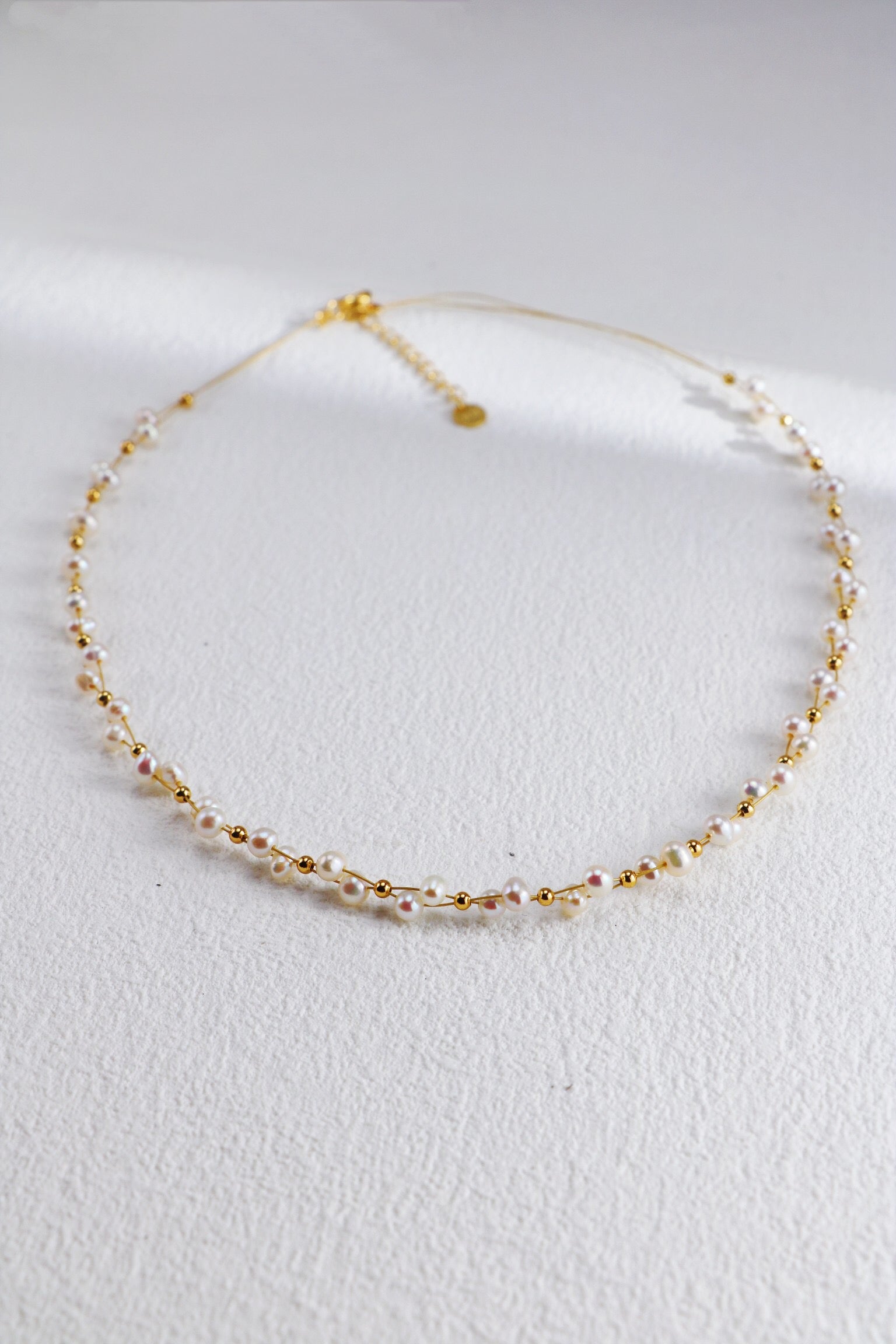 A beautifully handcrafted Twisted Freshwater Pearl Beads Necklace featuring natural pearls and gold vermeil plating, elegantly displayed on a soft background.