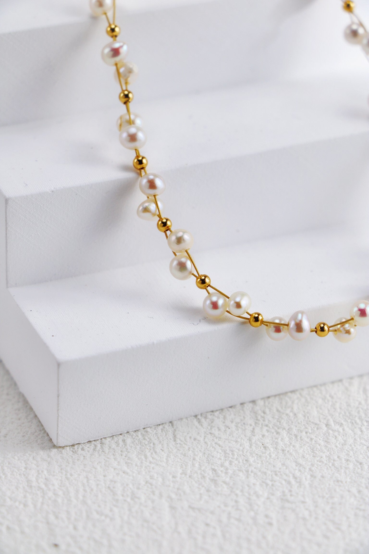 A beautifully handcrafted Twisted Freshwater Pearl Beads Necklace featuring natural pearls and gold vermeil plating, elegantly displayed on a soft background.