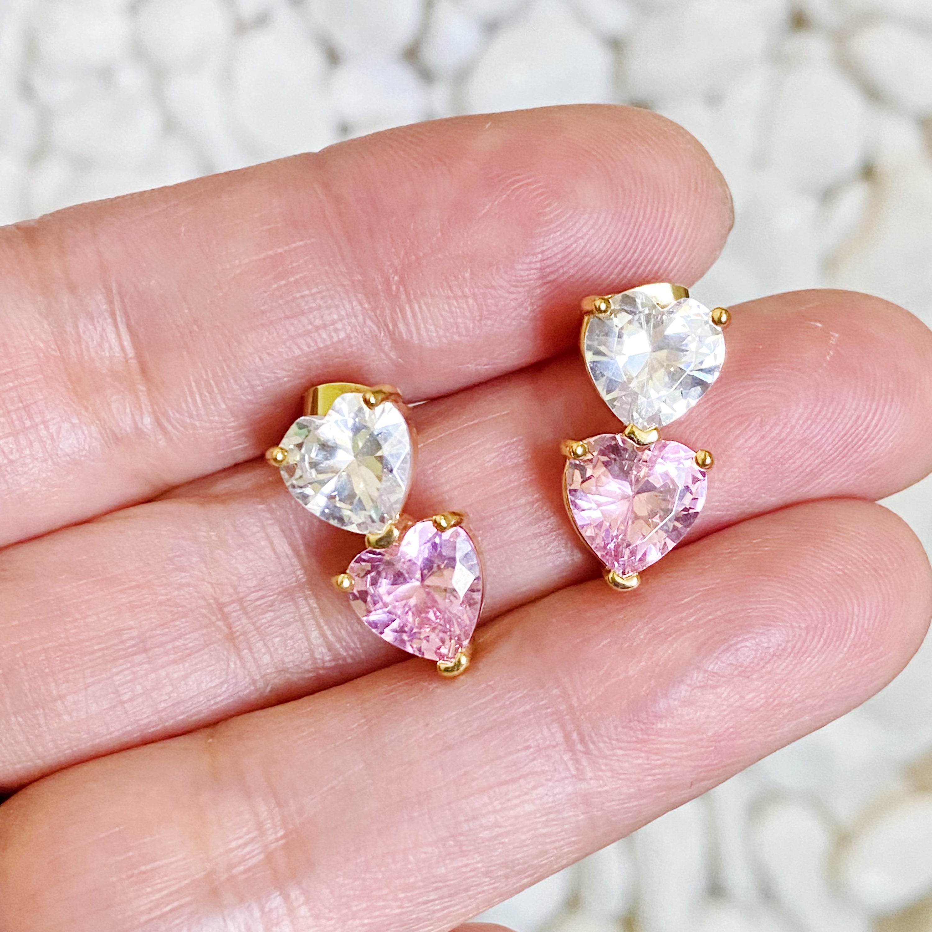 Two Colors Of Love Earrings featuring a sparkling two-toned heart design, crafted from gold plated brass with cubic zirconia.