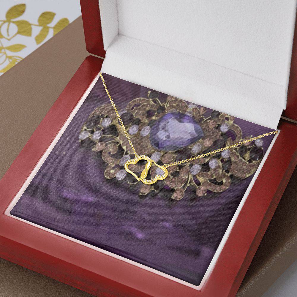 Two Hearts Together necklace featuring 10K solid yellow gold hearts and 18 pave set diamonds, displayed in a luxurious mahogany gift box.