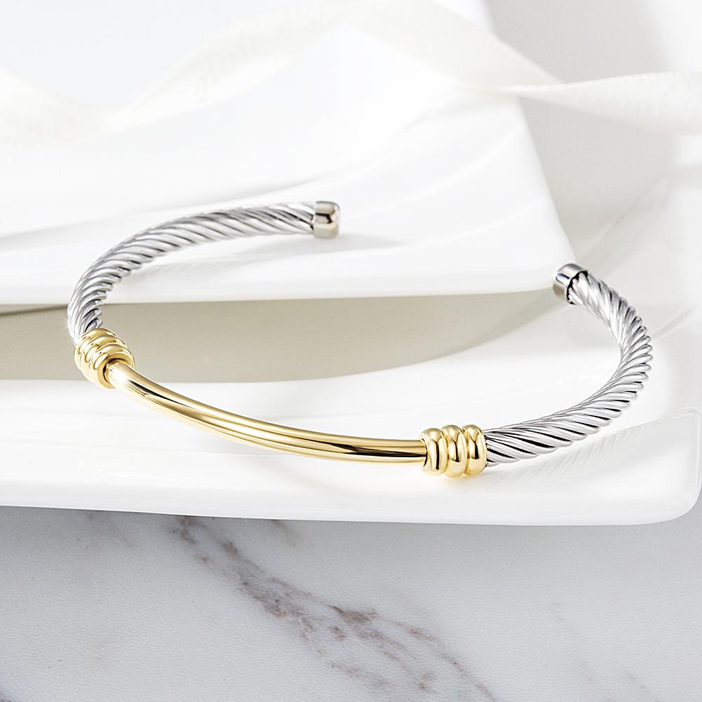 Two-Tone Textured Cable Cuff made of surgical stainless steel with gold plating, showcasing a modern and elegant design.