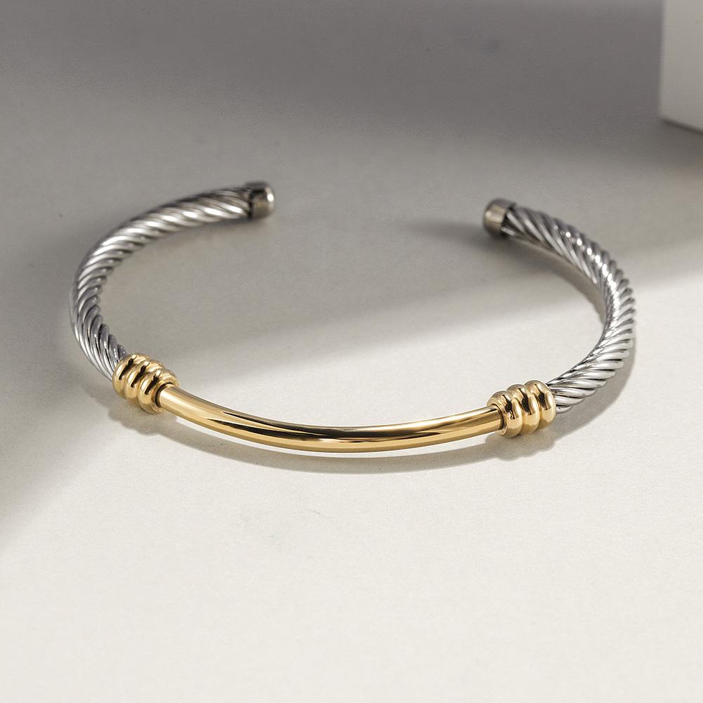 Two-Tone Textured Cable Cuff made of surgical stainless steel with gold plating, showcasing a modern and elegant design.