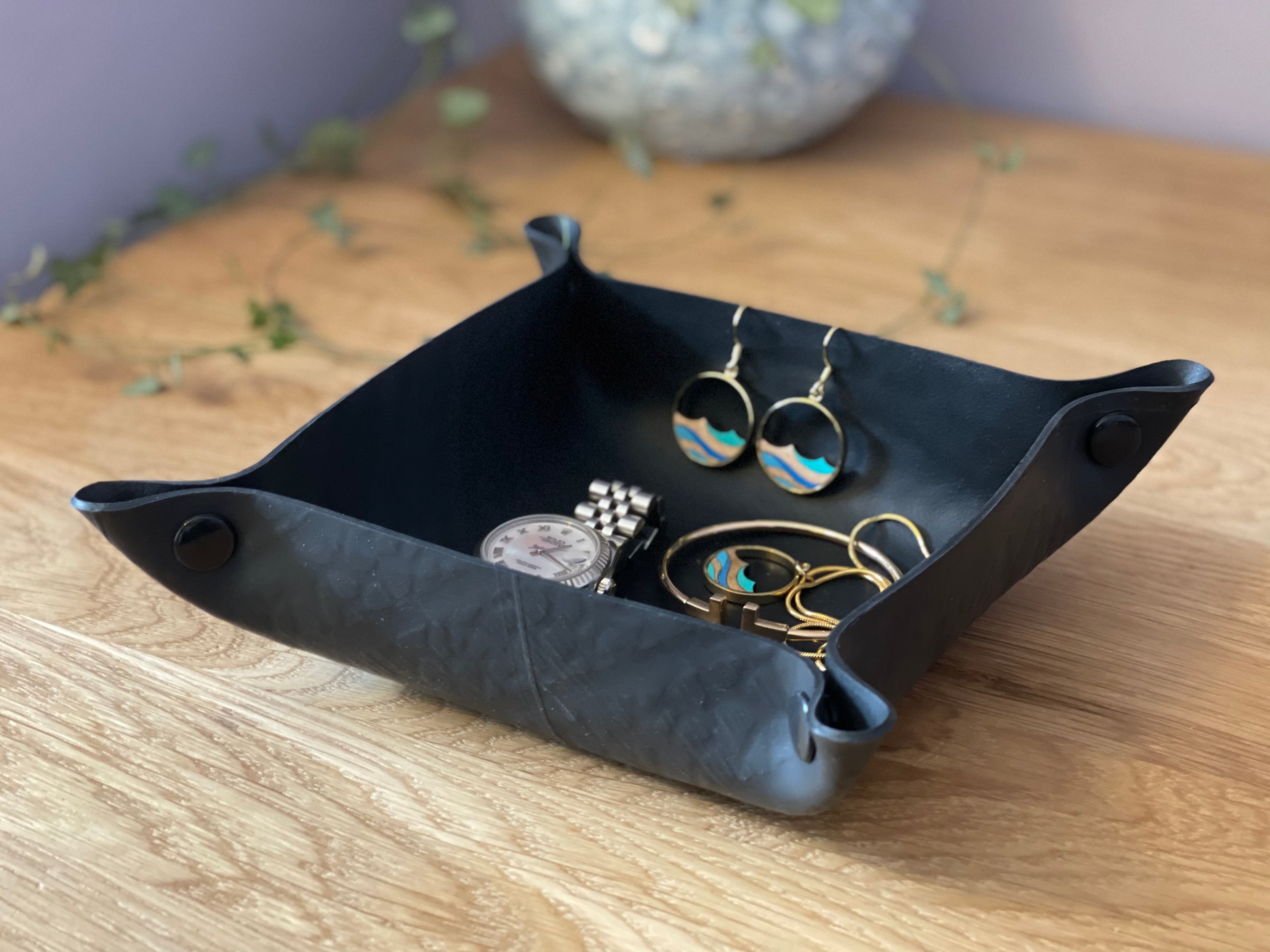 A handcrafted Upcycled Rubber Trinket Tray made from recycled tyre inner tubes, featuring a unique design and press-stud corners for versatility.